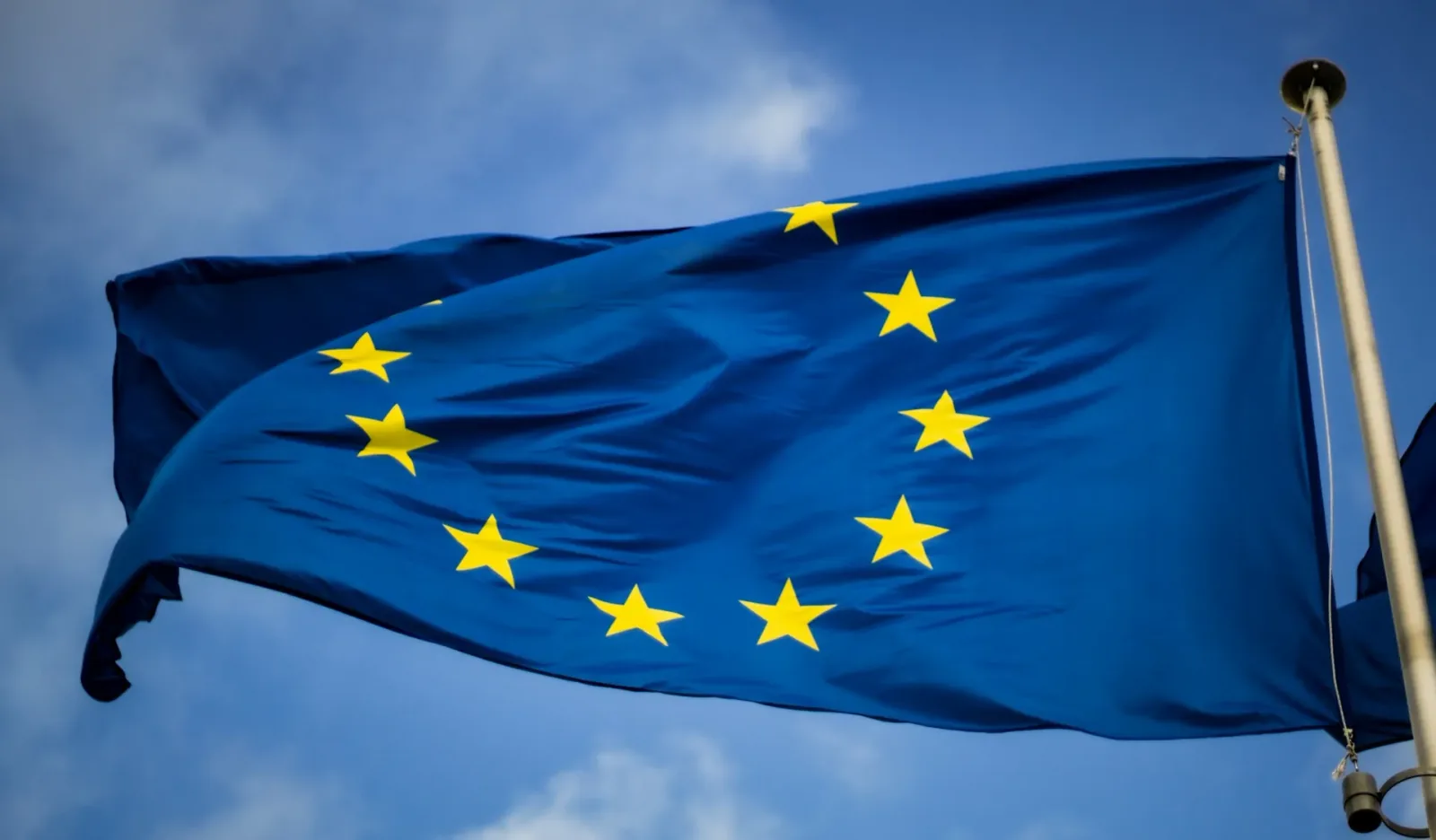 European Union flag waving against a blue sky